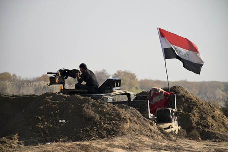 Iraqi Security forces with national flag enter downtown Ramadi, 70 miles (115 kilometers) west of Baghdad, Iraq, Sunday, Dec. 27, 2015. Islamic State fighters are putting up a tough fight in the militant-held city of Ramadi, slowing down the advance of Iraqi forces, Gen. Ismail al-Mahlawi, head of the Anbar military operations, said Sunday. (ANSA/AP Photo)